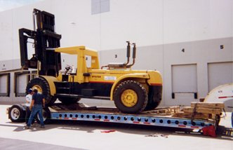 Forklift on a lowboy trailer
