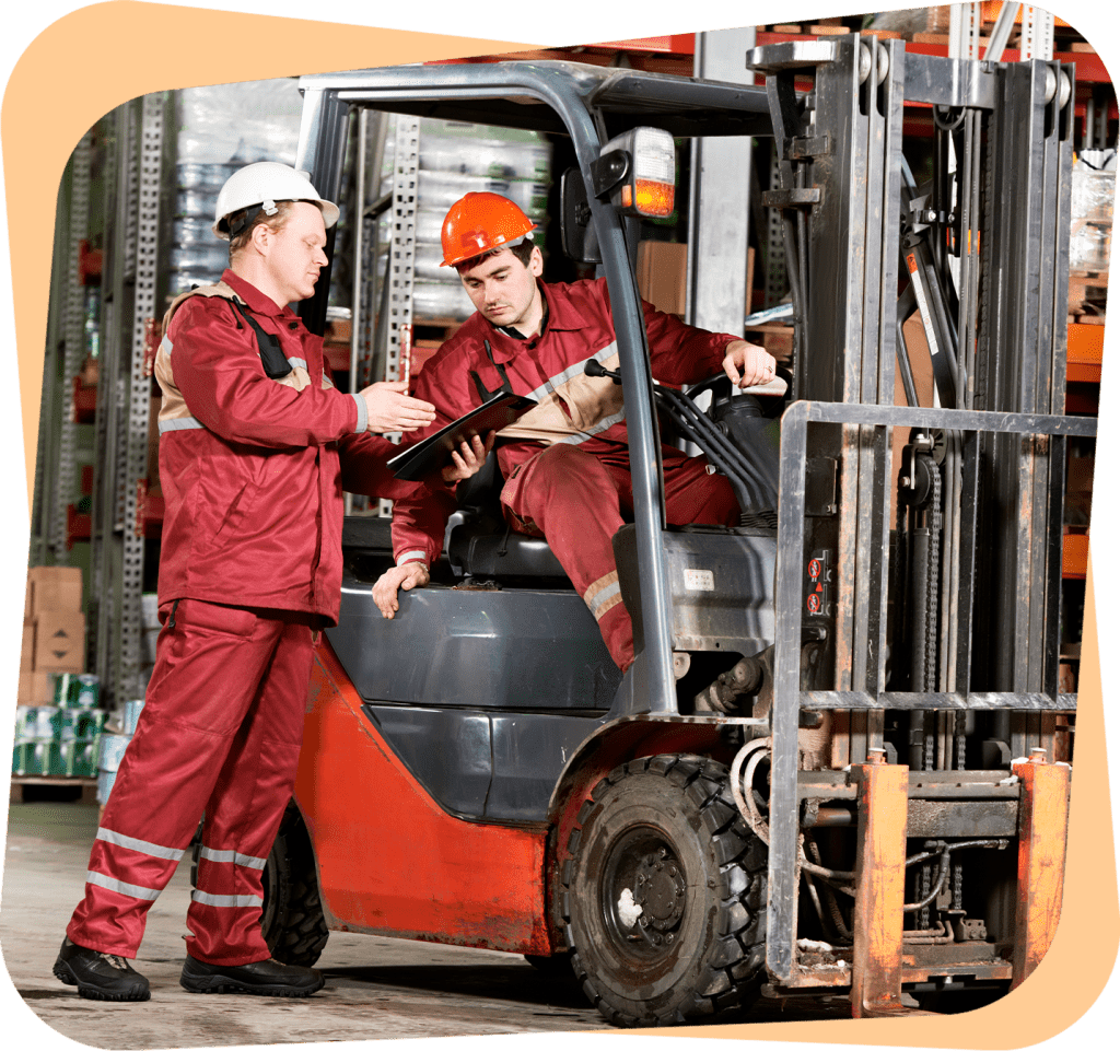 two men in red work on a forklift.