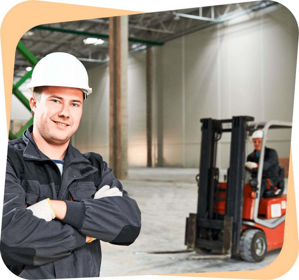 a man standing in a warehouse with his arms crossed.