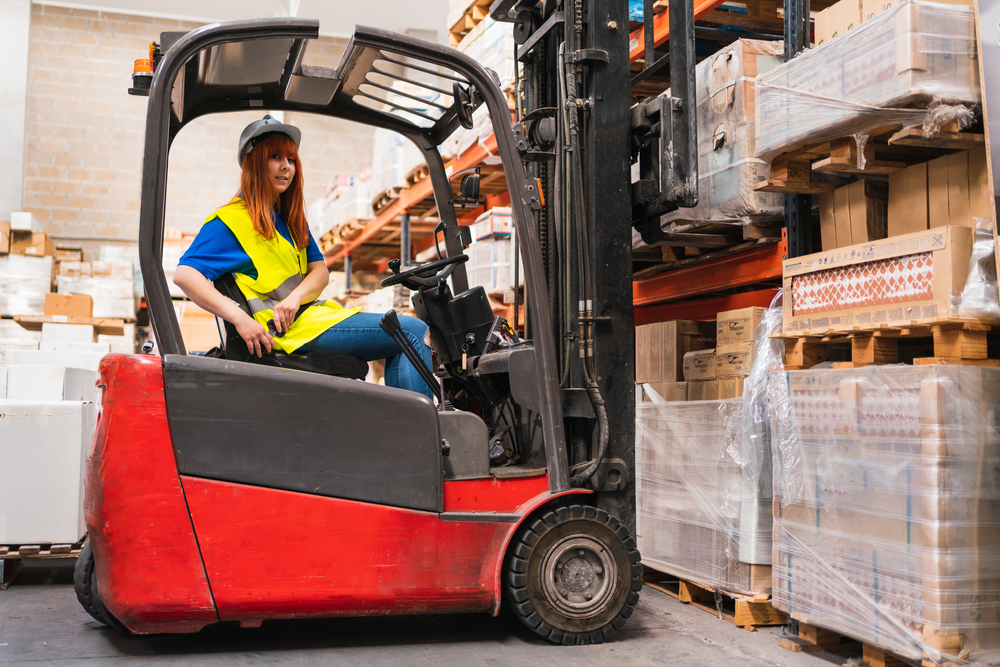 warehouse worker putting forklift seat belt on