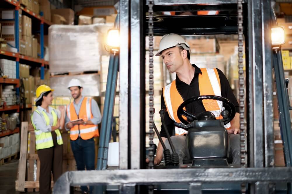 A forklift operator in a warehouse.